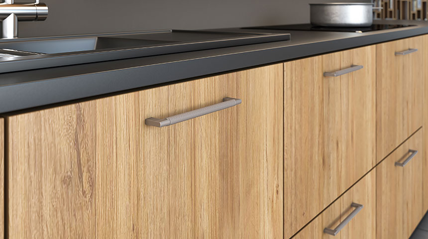 Arc Series handles in stainless look with knurled surface in kitchen setting