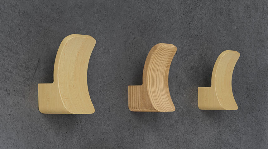 Loop wooden hooks in different sizes mounted on wall